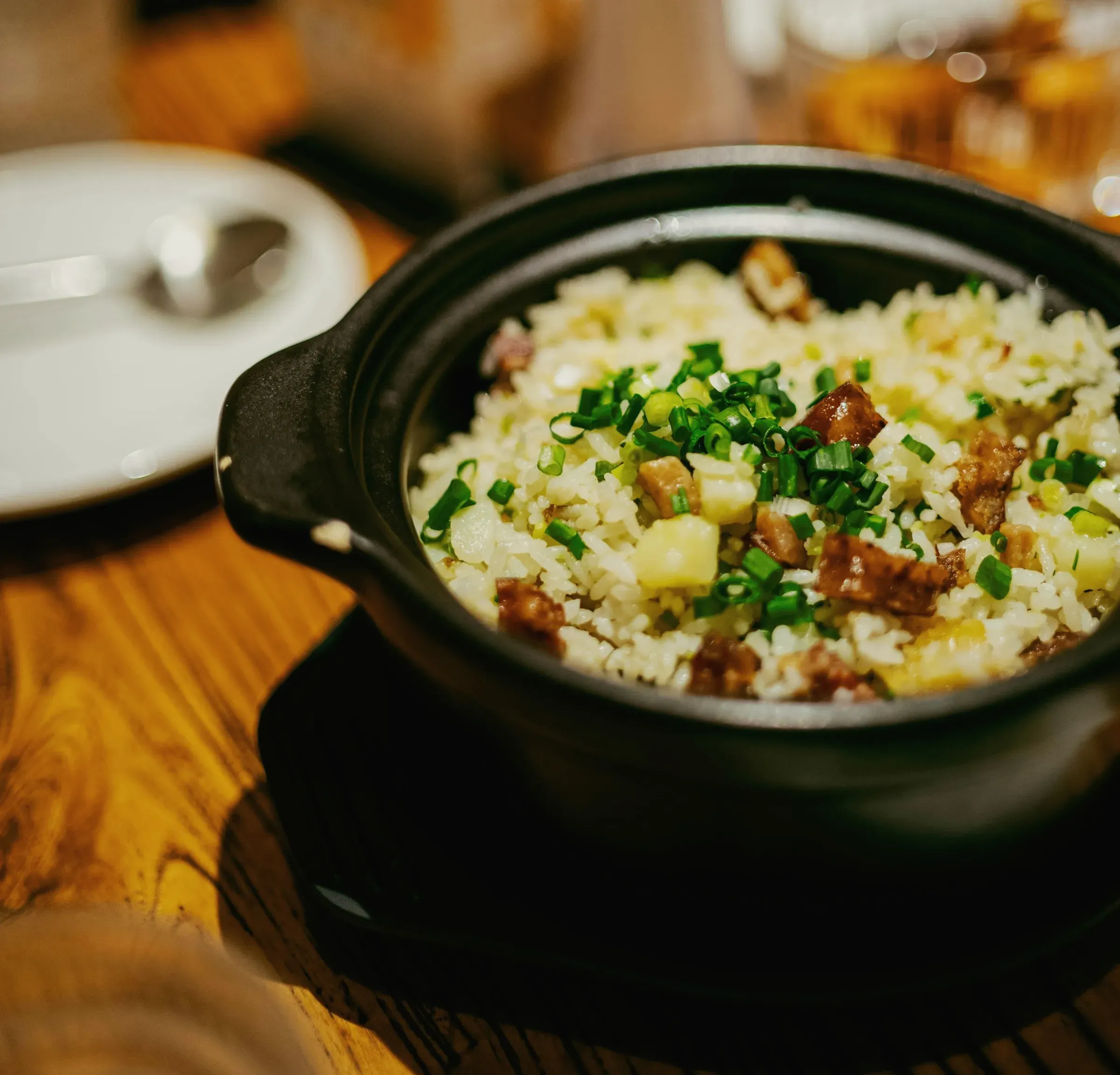 Rice in a black clay pot with chestnut, glazed pork and scallion