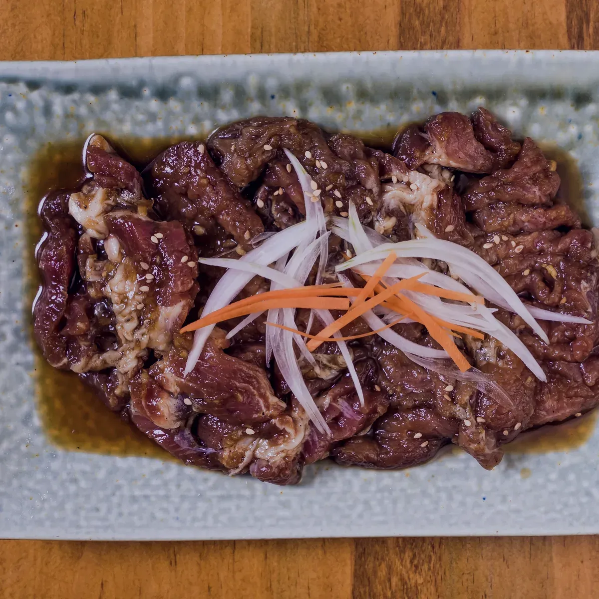 Soy-marinated beef bulgogi with onion and carrot