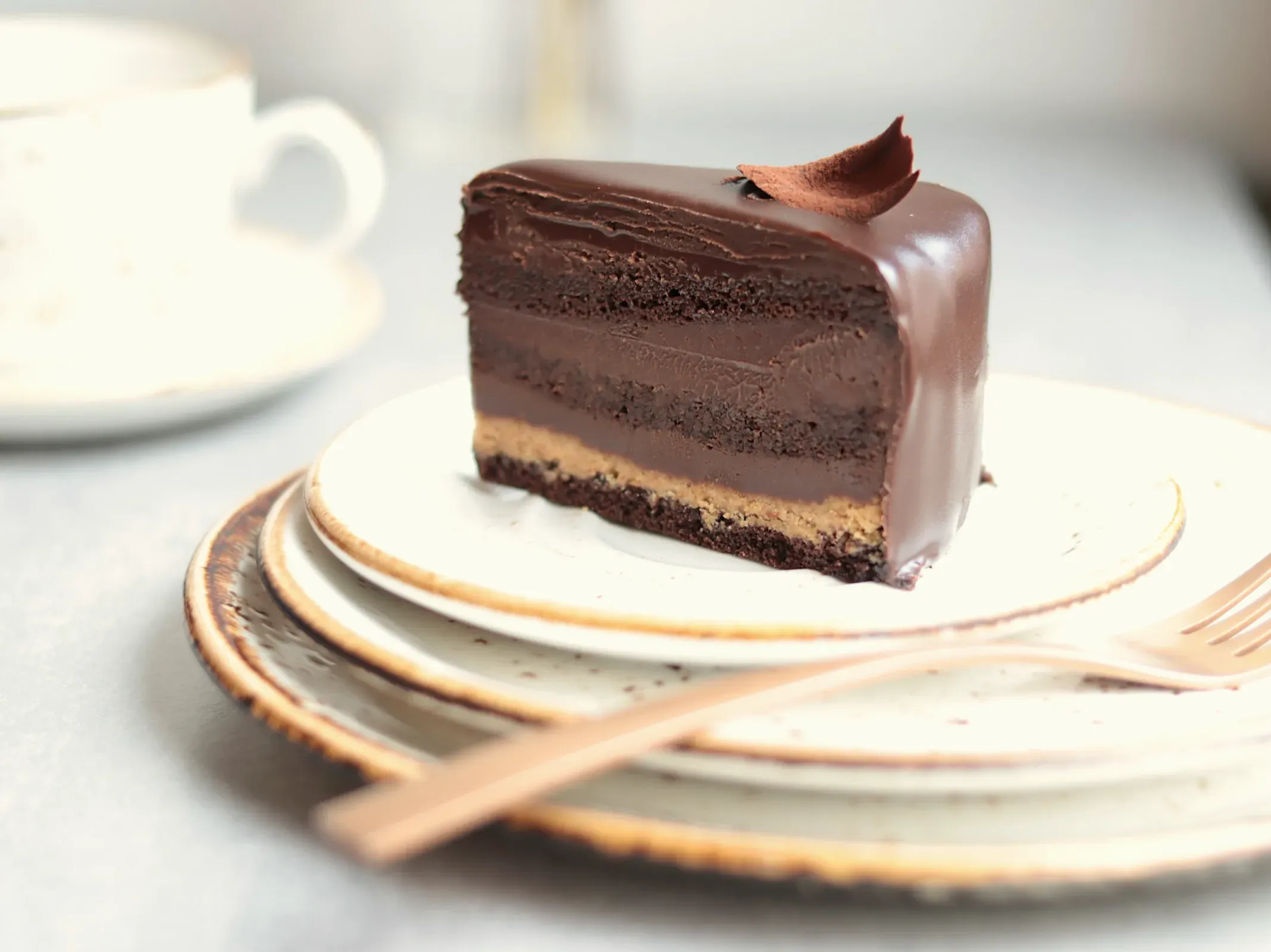 A slice of chocolate mousse cake under a glossy ganache