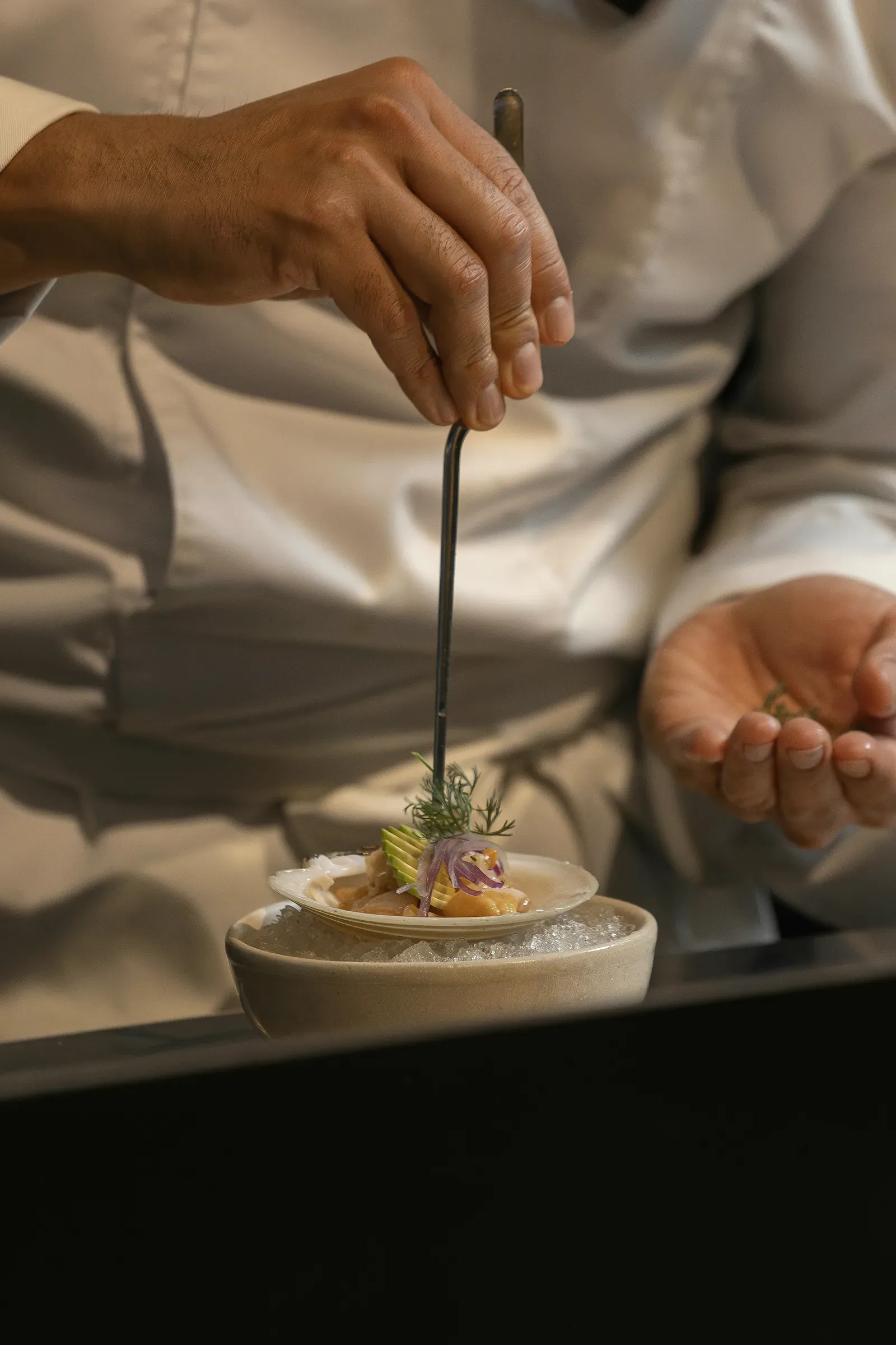 The kitchen garnishing a small plate for the New Year lunch