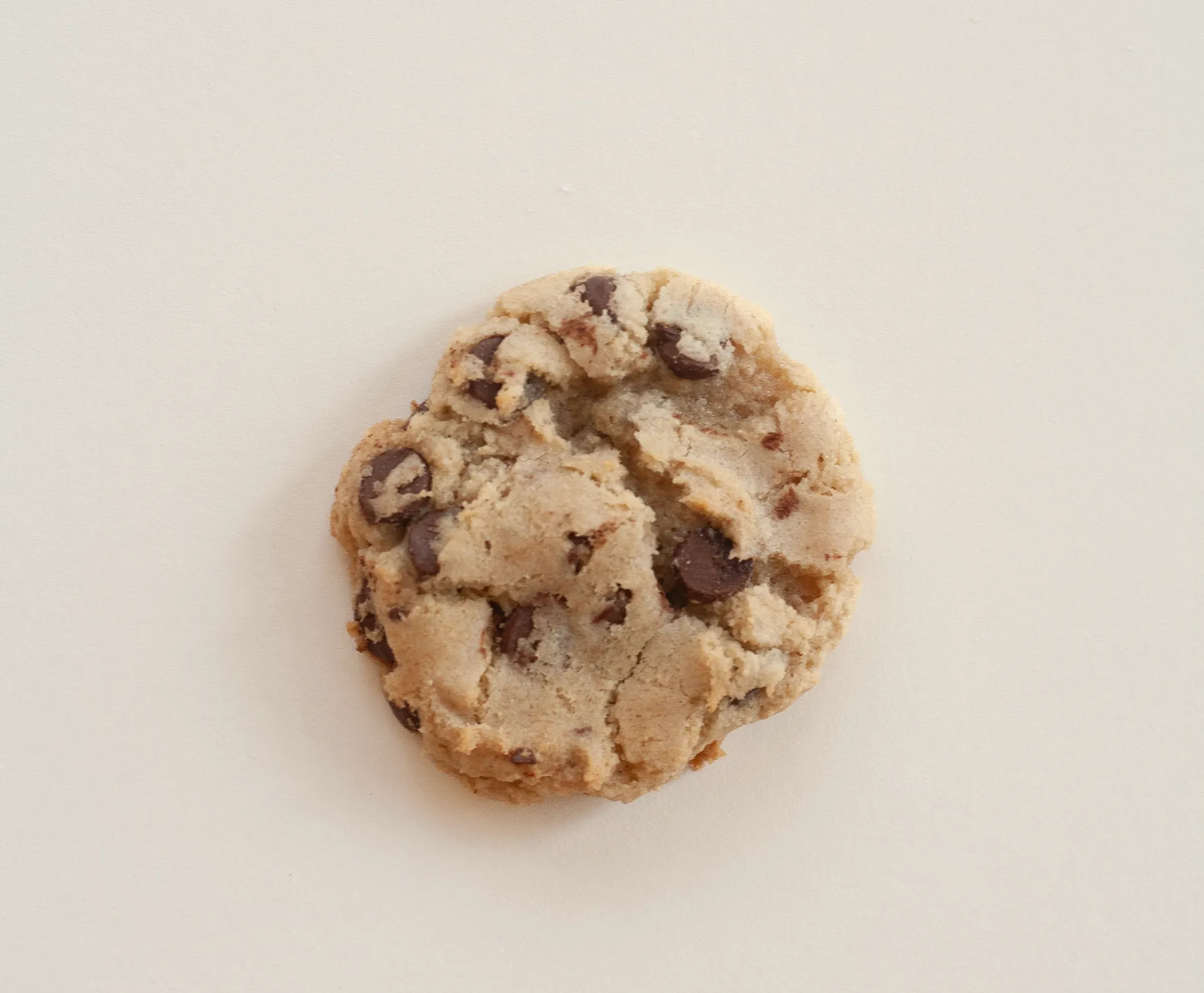 A large chocolate chip cookie with pools of melted chocolate
