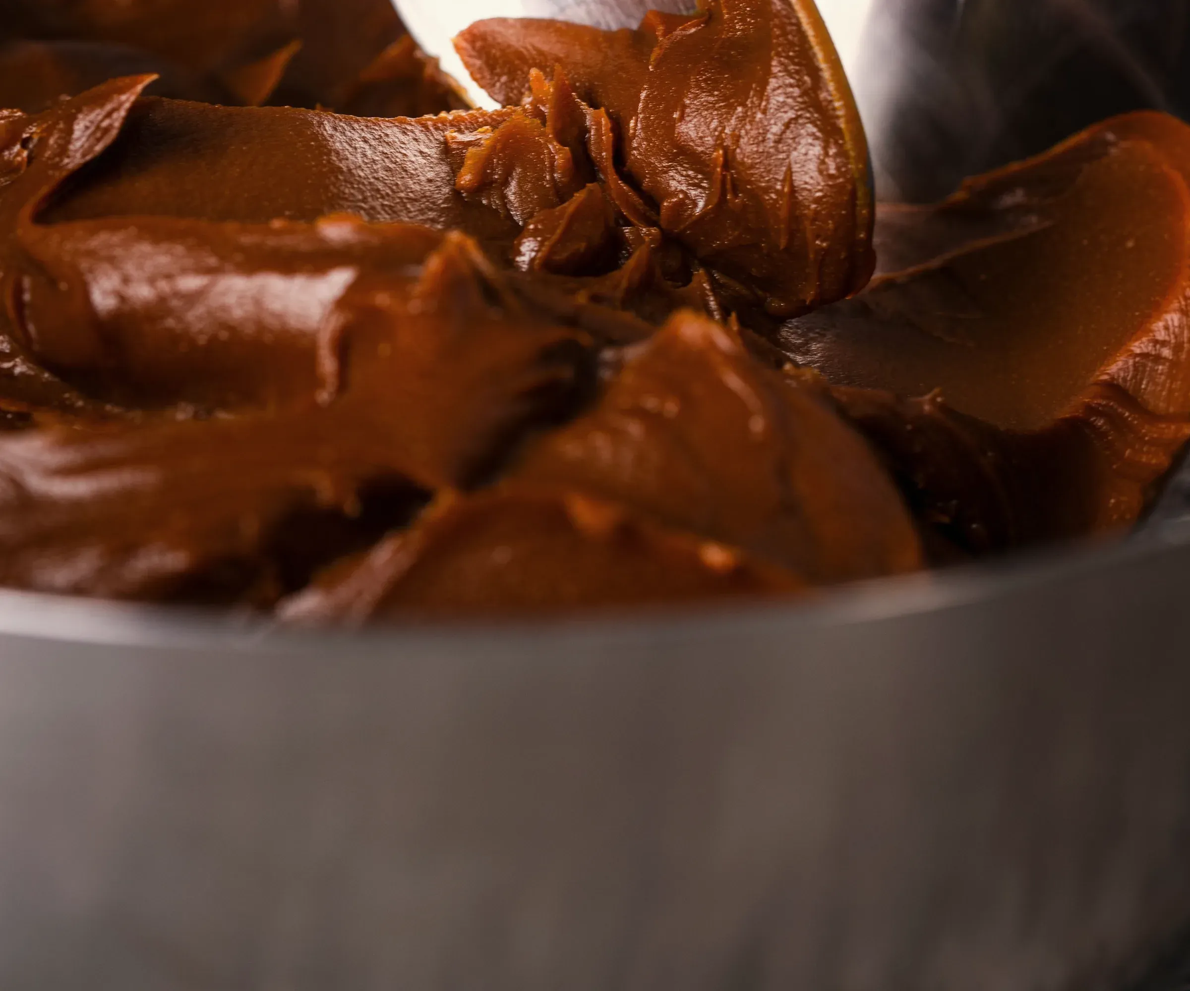 Glossy chocolate ganache in a bowl