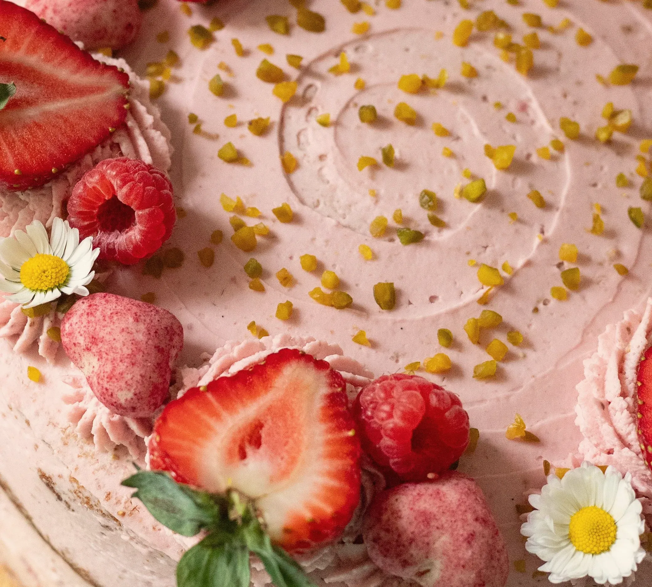 Pink strawberry cream on a cake, close up