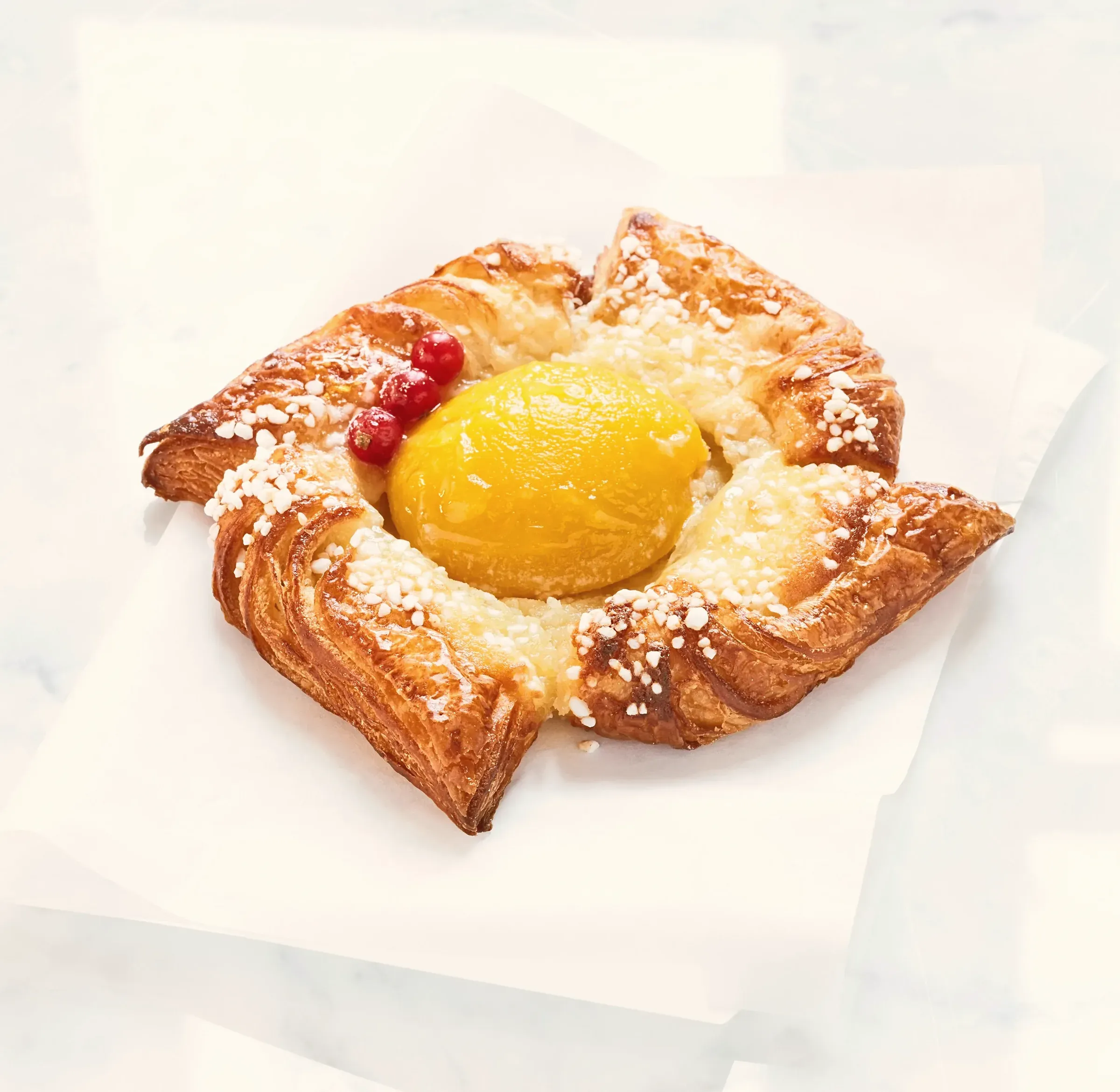 A glazed apricot danish, close up