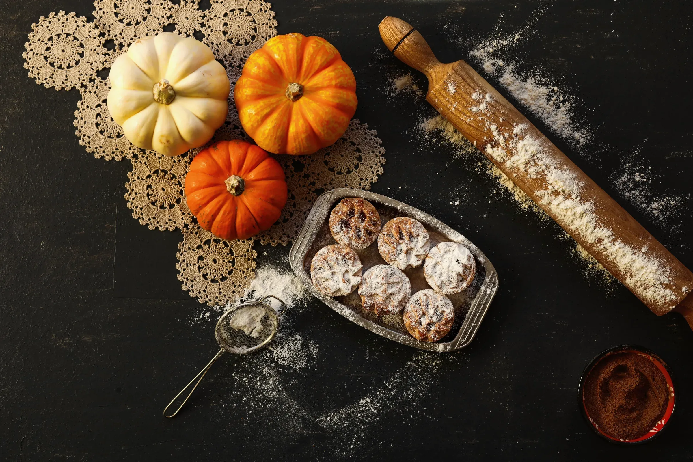 An autumn baking table with small pumpkins and pastries