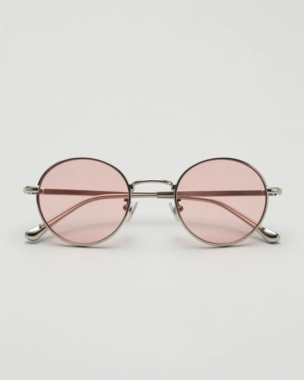 HALO from the front, thin silver titanium round sunglasses with rose lenses