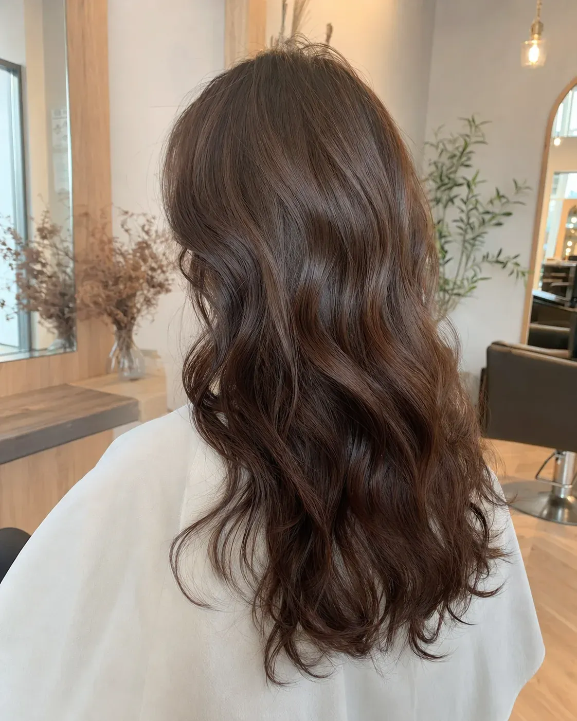 Long, loose brown curls seen from behind