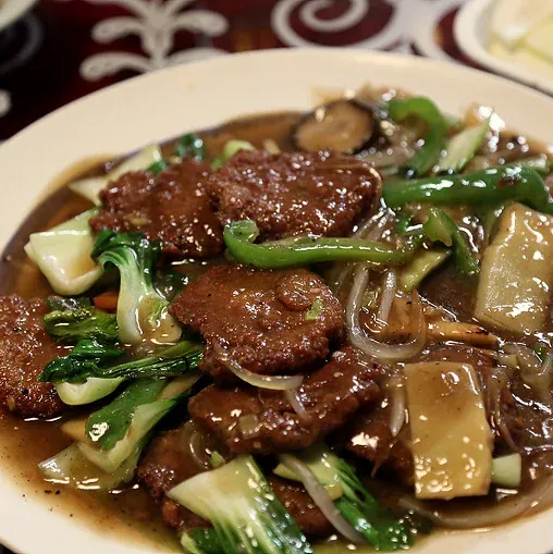 Flattened pork meatballs braised in dark soy sauce with bok choy and peppers