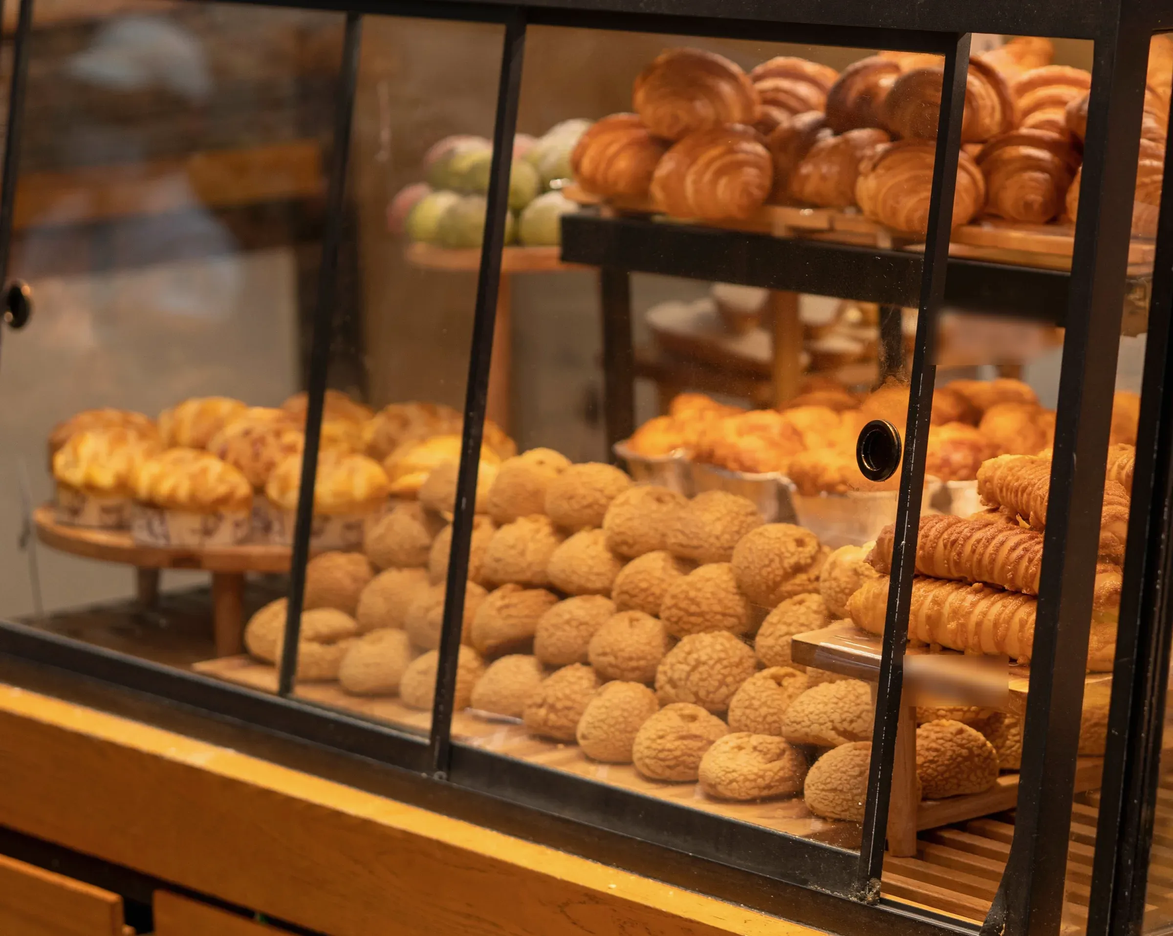 The Pasadena pastry case: croissants and cream puffs behind glass