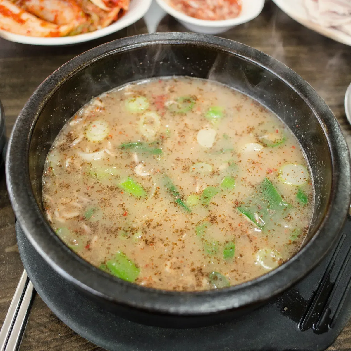 Sundae soup with perilla seed and green onion in a black earthenware bowl