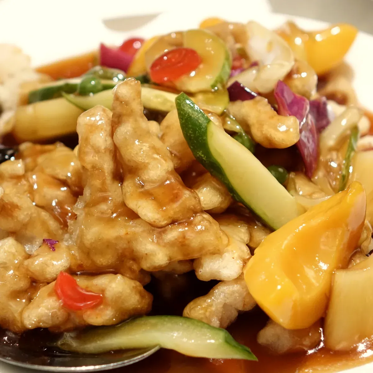 Crisp pork in sweet and sour sauce with cucumber, pepper and pineapple