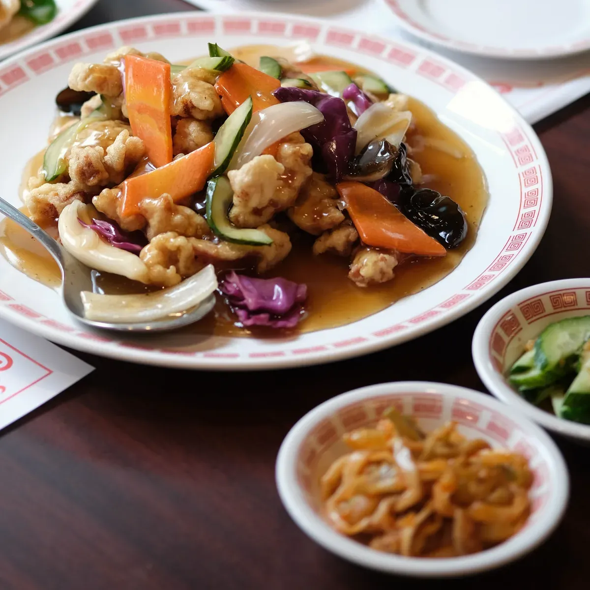 Crispy pork in sweet and sour sauce with wood ear, carrot, cucumber and cabbage