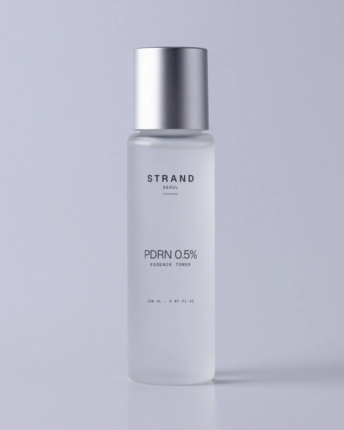 PDRN Essence Toner: a tall frosted glass bottle with a silver cap
