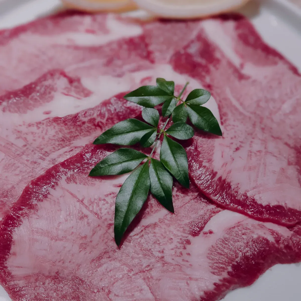 Thin slices of raw beef tongue