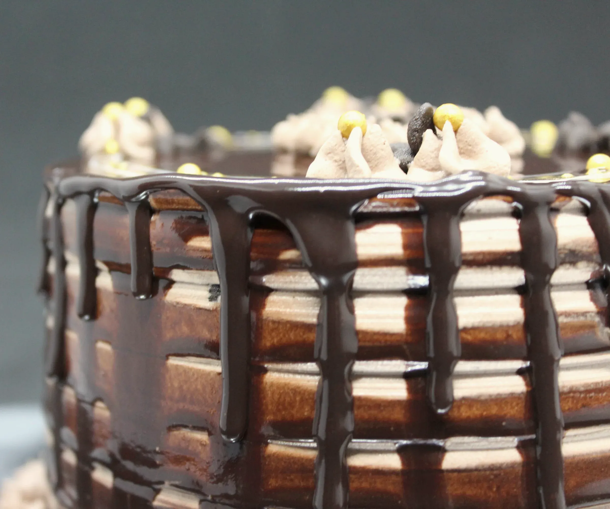 A layer cake with a chocolate drip