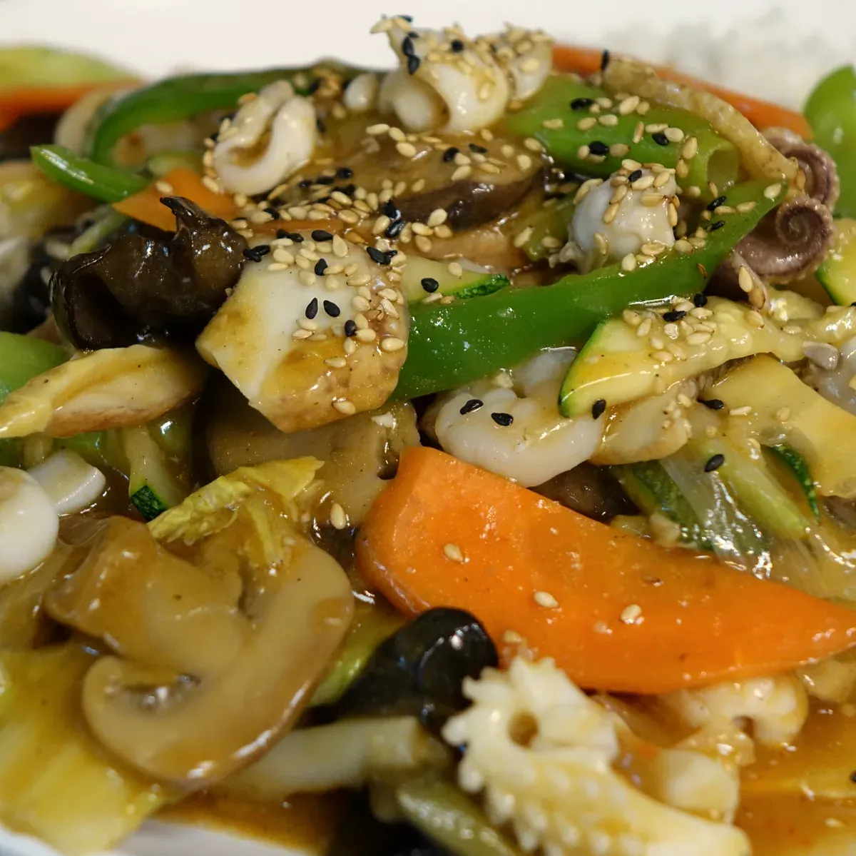 Squid, shrimp, mushrooms and vegetables braised in a light glossy sauce